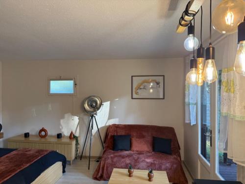 a bedroom with a bed and a table in it at Euronat naturist studio in Grayan-et-lʼHôpital
