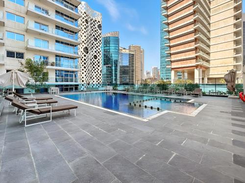 a swimming pool on the roof of a building at Unlock Metropolis Business Bay in Dubai
