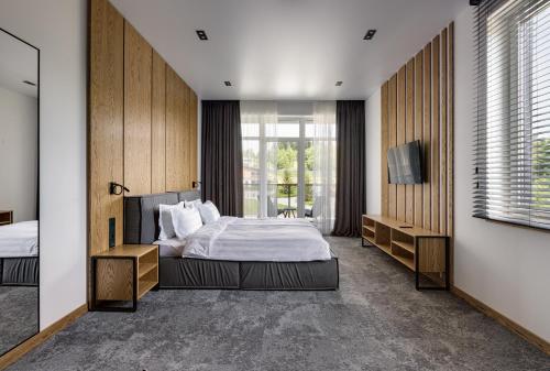 a bedroom with a bed and a television in it at Apartel Skhidnytsya in Skhidnitsa