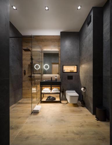 a bathroom with a shower and a sink and a toilet at Apartel Skhidnytsya in Skhidnitsa