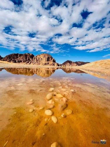 a body of water in the middle of a desert at Wadi rum fun time in Wadi Rum