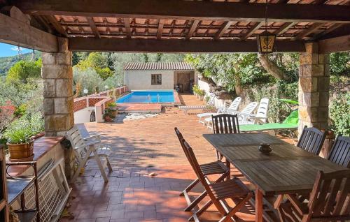 a patio with a table and chairs and a pool at La Nature in Seillans
