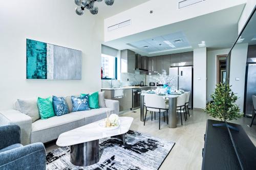 a living room with a couch and a table at Nasma - Modern Apartments with Balcony in Azizi Riviera in Dubai