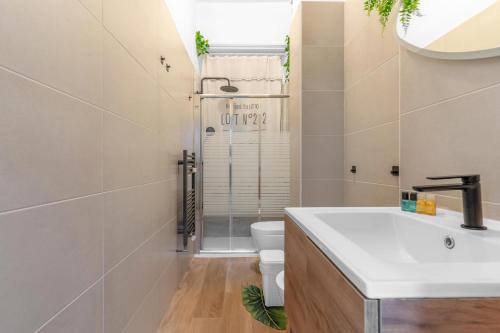 a bathroom with a white sink and a toilet at Naviglio Pop House zona Humanitas-Forum con wifi in Rozzano
