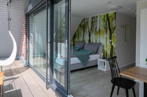 a small room with a bed and a table with a chair at Plauderei Café und Hotel in Bad Zwischenahn