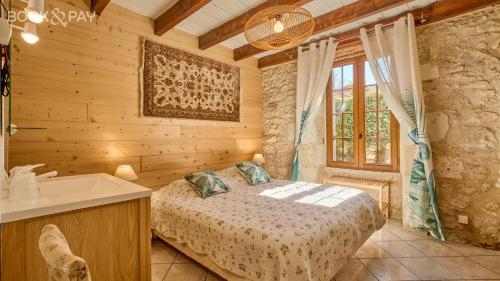 a bedroom with a bed and a tub and a sink at Chez Moutier in Monestier