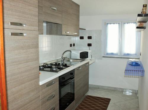 a kitchen with a sink and a stove top oven at Casa Vacanze Nuraghe Talia in Olmedo