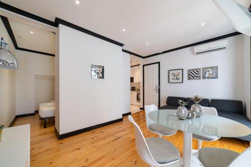 a living room with a glass table and chairs at Bliss Lisbon Apartments - Bairro Alto in Lisbon