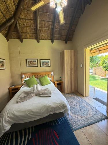 a bedroom with a bed and a ceiling fan at SETLHARE GUEST LODGE in Ganyesa
