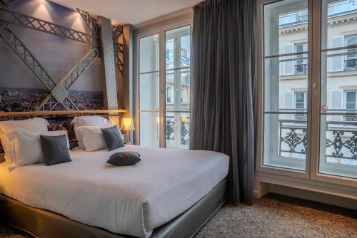 a bedroom with a large bed with a large window at Secret de Paris - Hotel & Spa in Paris