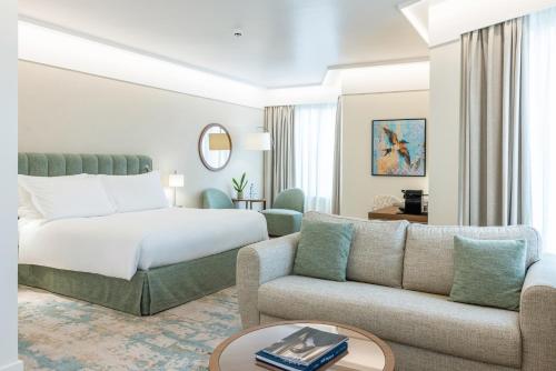 a hotel room with a bed and a couch at Crowne Plaza Porto by IHG in Porto
