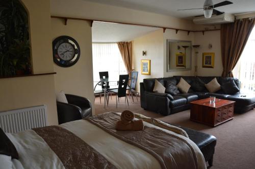 a bedroom with a large bed and a living room at The Smugglers Inn in Minehead