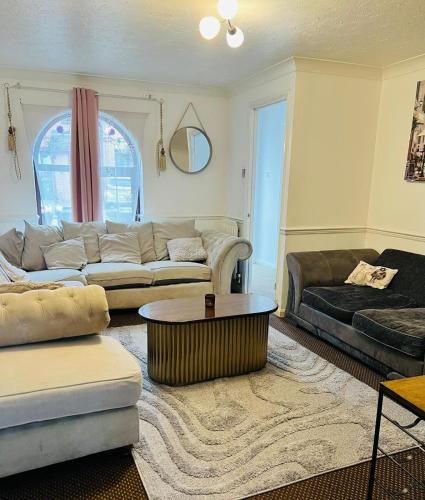 a living room with a couch and a coffee table at Olive, 3Bedrooms,1 extra Rm, Sleeps 9 with Garden, Free Parking in Grays, Lakeside, London in Grays Thurrock