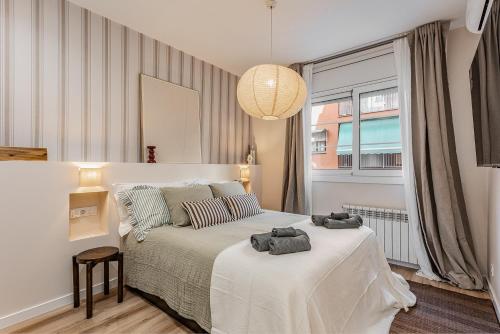 a bedroom with a bed with two towels on it at Comfortable and spacious flat in Barcelona in Barcelona