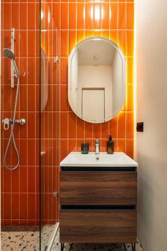 a bathroom with a sink and a mirror at Blueloft 47 l studio with balcony Tashkent City Center in Tashkent
