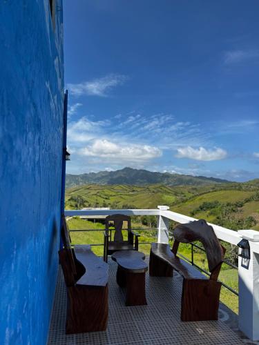 a balcony with benches and a view of the mountains at Bryans Farmstead in Basco