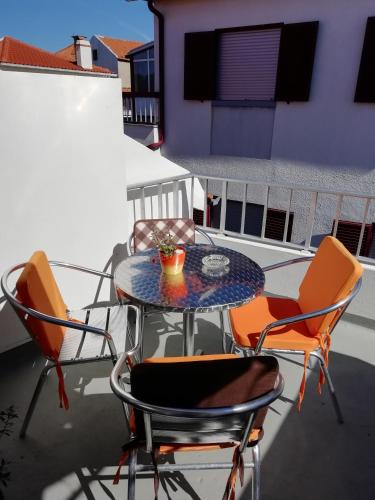 a patio table and chairs on a balcony at Casa Aguarela in São Romão