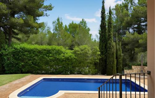 a blue swimming pool in a yard with trees at Villa Rondo in Costa de la Calma