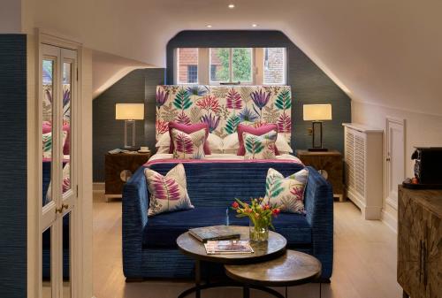 a living room with a couch and a bed at Langshott Manor - Luxury Hotel Gatwick in Horley