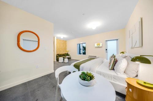 a living room with a white couch and a table at El Jardin by Renzzi in Miami