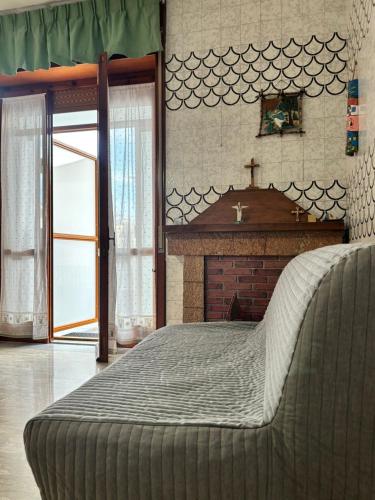 a bedroom with a large bed with a fireplace at Metis Apartments Bellizzi in Bellizzi