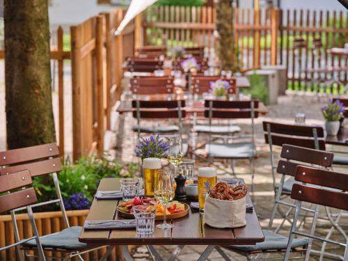 a table with food and drinks on a patio at Classik Hotel Martinshof, Messe München in Munich