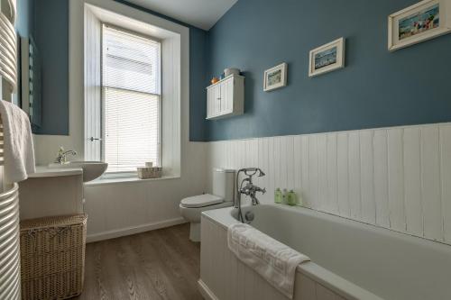 a bathroom with a tub and a toilet and a sink at Upper Rocklands - Elie in Earlsferry