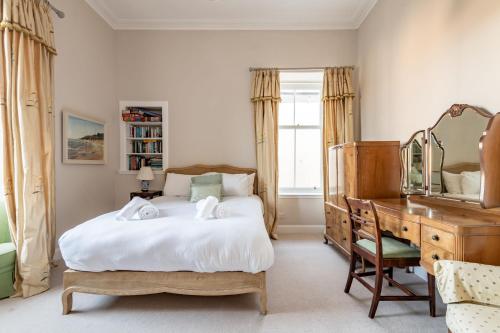 a bedroom with a bed and a dresser and a desk at Upper Rocklands - Elie in Earlsferry