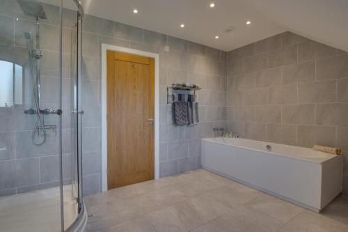 a bathroom with a bath tub and a shower at 3 Bed in Coelbren oc-way238 in Coelbren