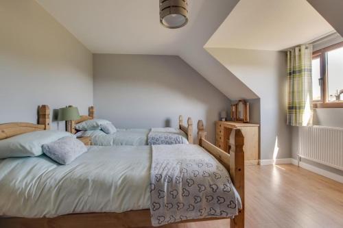 a bedroom with two beds and a window at 3 Bed in Coelbren oc-way238 in Coelbren
