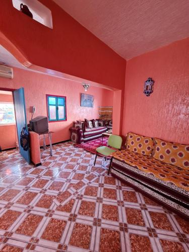 a large living room with a couch and a television at Maison Banana in Aourir