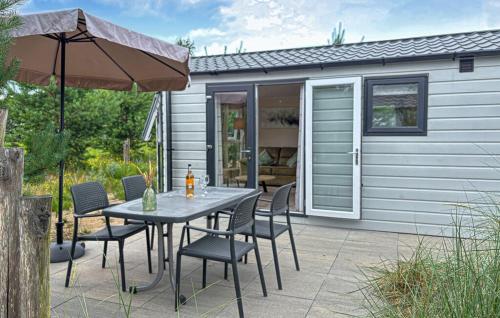 a patio with a table and chairs and a shed at Europarcs Zuiderzee Berkel-4 #363 in Biddinghuizen