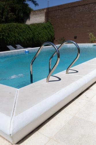 a white mattress sitting next to a swimming pool at Primer Peldaño - Casa Quinta in Junín