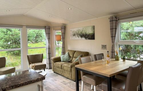 a living room with a table and a couch at Europarcs Zuiderzee Berkel-4 #363 in Biddinghuizen