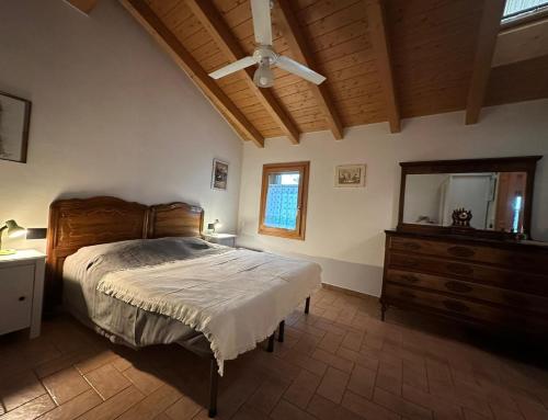 a bedroom with a bed and a dresser and a mirror at Castello San Romano in Baiso