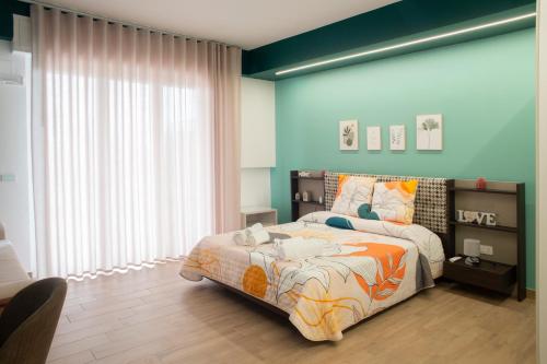 a bedroom with a bed and a large window at Acquamarina B&B in Vasto