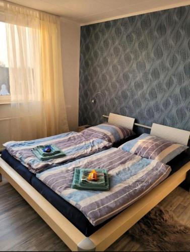 two beds in a bedroom with a table on it at Sarra&Mo Ferienwohnung in Duisburg
