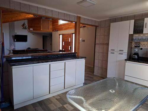 a kitchen with a tub in the middle of it at Casa para 8 personas in Licán Ray