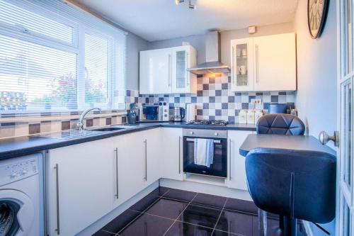 a kitchen with a sink and a dishwasher at Gellionen - 2 Bedroom House - Clydach in Clydach