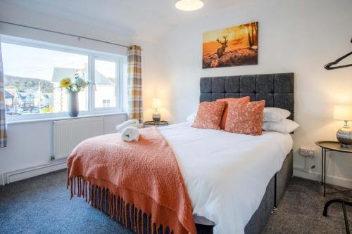 a bedroom with a large bed and a window at Gellionen - 2 Bedroom House - Clydach in Clydach