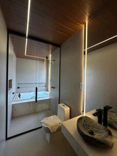 a bathroom with a sink and a toilet in it at Âmbar Chalés 2 in Ametista do Sul