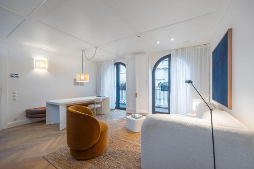 a bedroom with a bed and a desk and a chair at Hotel Montaigne in Ostend