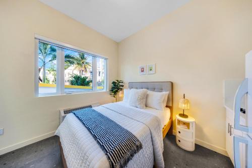 a bedroom with a bed and a window at El Jardin Inn in Miami
