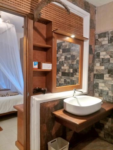 a bathroom with a sink and a mirror at H3 Hilltop Heaven in Ella