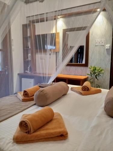 a group of towels sitting on top of a bed at H3 Hilltop Heaven in Ella