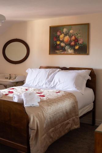 a bedroom with a bed with flowers on it at Half Moon House - Timeless Charm with Sea Views in Scarborough