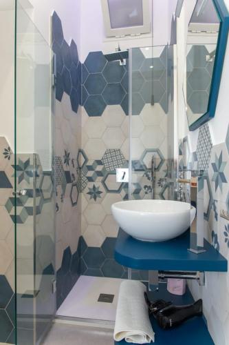 a bathroom with a sink and a shower at Maruzzé luxury room in Albori