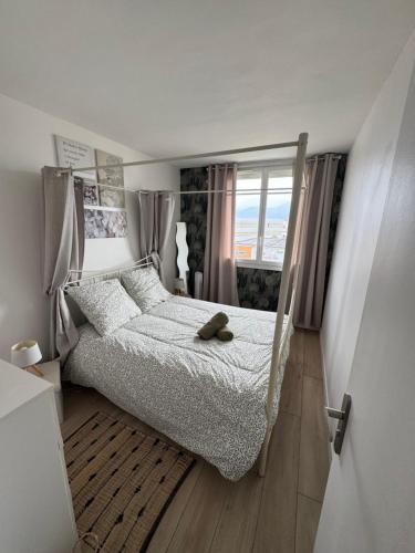 a bedroom with a bed with a teddy bear on it at Le 306 Beauvert Parking gratuit in Grenoble