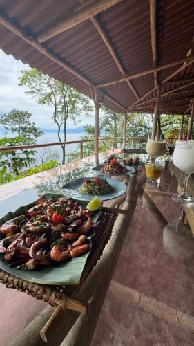 a table with several plates of food on it at Glamping Sitio das Tartarugas in Praia da Longa