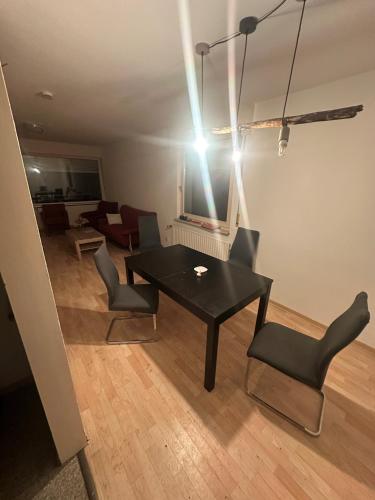 a living room with a black table and chairs at Turp Residenz Fewo in Blomberg